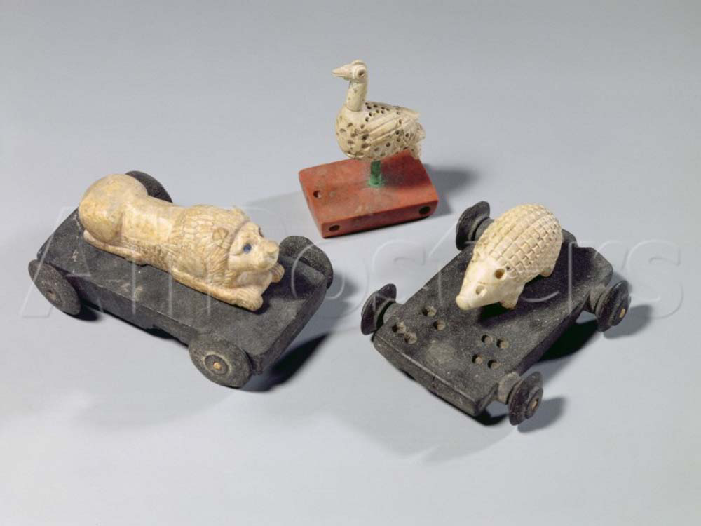 Three ancient Persian pull toys — wheeled animal figures from one of the world's earliest civilizations